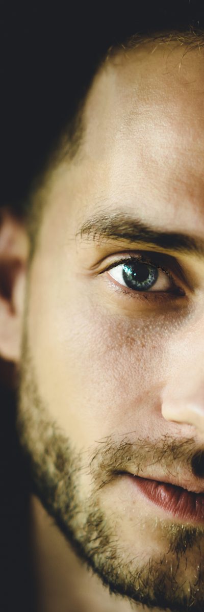 Man. close-up portrait, smiling, cunning eyes